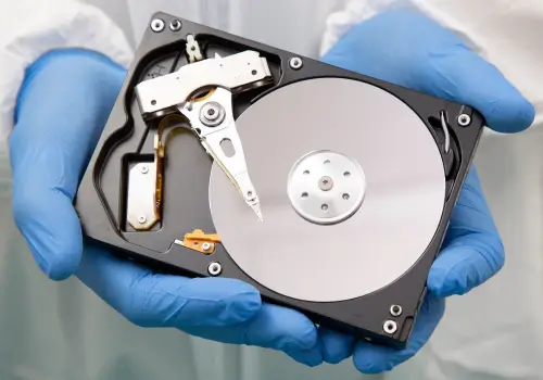 A data recovery engineer showcases the inside of a hard disk drive (HDD).